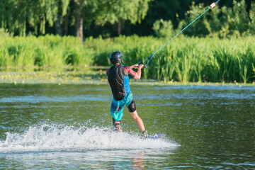 Kiteboarder enjoy surfing on the lake surface.