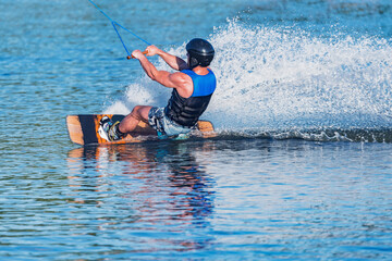 Fototapeta premium Kiteboarder enjoy surfing on the lake surface.