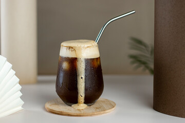 Iced coffee. Coffee cold brew drink cocktail with ice cube on abstract background. Summer...