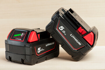Lithium battery for cordless drill. Screwdriver battery. Four batteries with a charge indicator lie...
