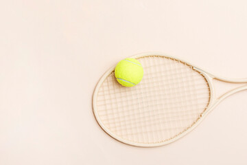 Beige tennis racket and yellow ball on beige background. Horizontal sport theme poster, greeting...