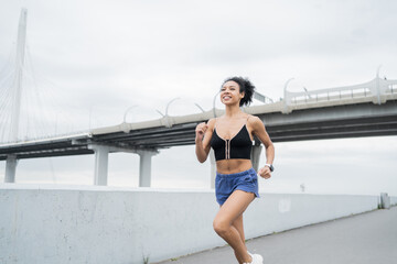 Female runner runs in sports clothes, active exercises for health