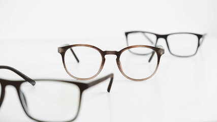 Three optical glasses of different shapes on a white background