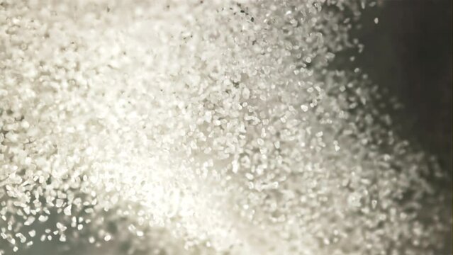 A bunch of sugar goes up and down. Macro background. Top view. The texture of sugar. Filmed is slow motion 1000 fps.