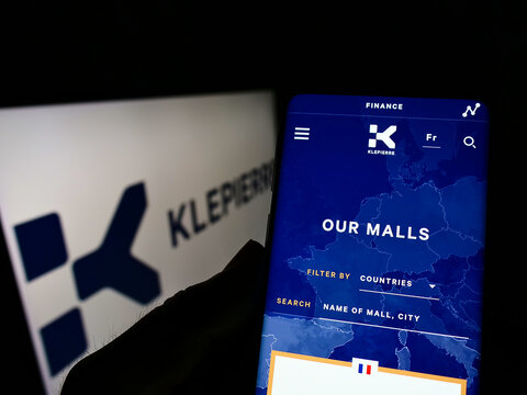 Stuttgart, Germany - 02-06-2022: Person holding cellphone with webpage of French shopping center company Klepierre SA on screen in front of logo. Focus on center of phone display.