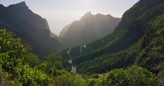 Sunset in Masca Valley and Gorge, Tenerife, Canarian Islands, Spain. Mountain ranges. Road with moving cars. Serpentine.