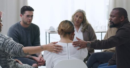 Woman crying and being comforted during group therapy. Upset and anxious patient sharing trauma story with diverse people and victims. Stressed, seeking help and support for mental health and wellness