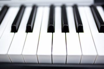 Keys of a synthesizer or grand piano closeup. Monochrome music concept background.