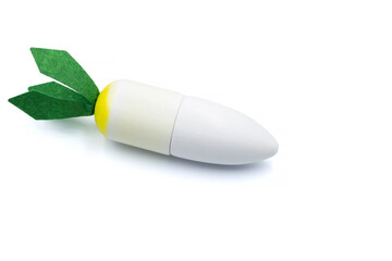 Kids toy wooden vegetables in background close up. Childrens developing wooden game. White carrot