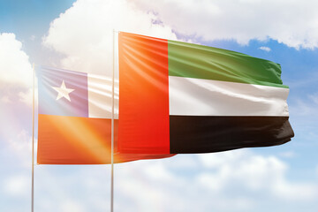Sunny blue sky and flags of united arab emirates and chile