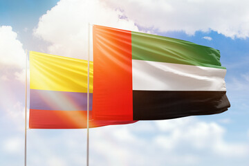 Sunny blue sky and flags of united arab emirates and colombia