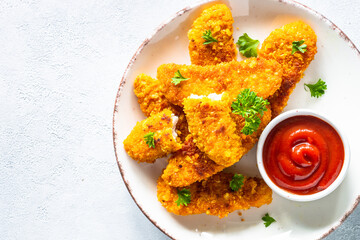 Chicken nuggets with ketchup sauce.