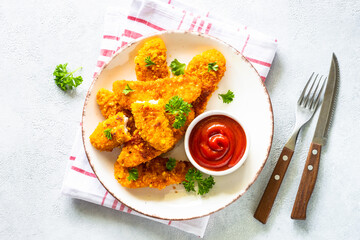 Chicken nuggets with ketchup sauce.