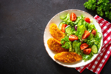 Chicken nuggets with fresh salad.