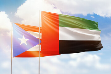 Sunny blue sky and flags of united arab emirates and puerto rico