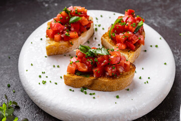 italian bruschetta with fresh tomatoes, basil, garlic, olive oil and cheese