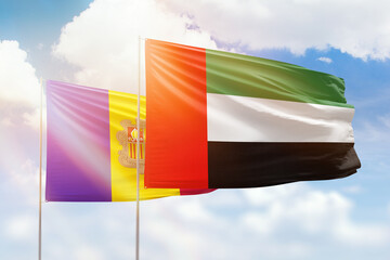 Sunny blue sky and flags of united arab emirates and andorra
