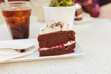 Japanese chocolate cheesecake with raspberry jam and whipped cream on top