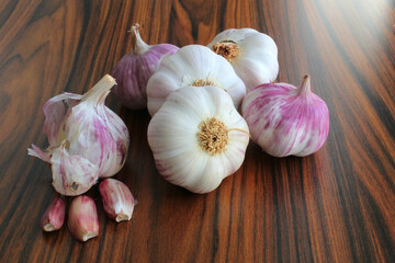 Garlic bulb. Garlic bulbs on the rustic wooden table under window back light. Brazilian seasonings.