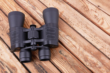 Binoculars on wood