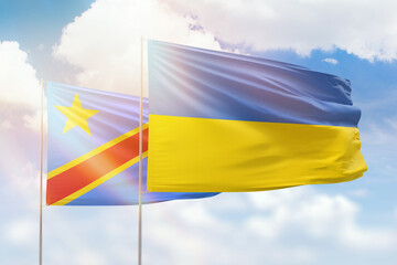 Sunny blue sky and flags of ukraine and dr congo