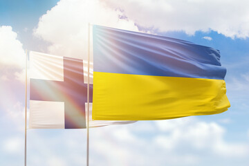 Sunny blue sky and flags of ukraine and finland