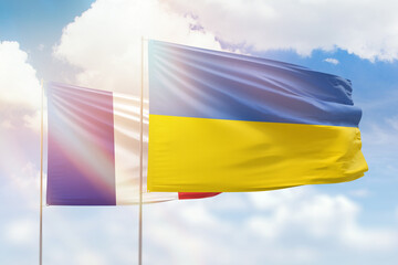 Sunny blue sky and flags of ukraine and france