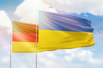 Sunny blue sky and flags of ukraine and germany