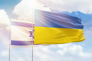 Sunny blue sky and flags of ukraine and israel