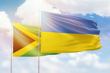 Sunny blue sky and flags of ukraine and jamaica