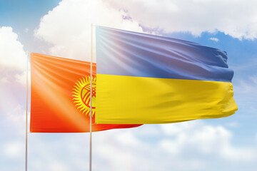 Sunny blue sky and flags of ukraine and kyrgyzstan