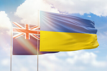 Sunny blue sky and flags of ukraine and new zealand