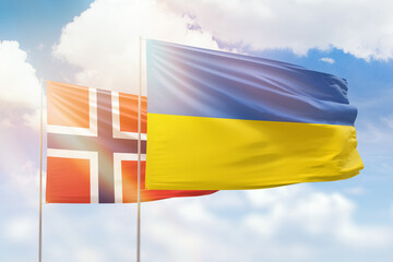 Sunny blue sky and flags of ukraine and norway
