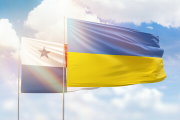 Sunny blue sky and flags of ukraine and panama