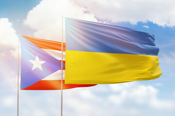 Sunny blue sky and flags of ukraine and puerto rico