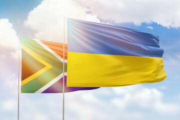 Sunny blue sky and flags of ukraine and south africa