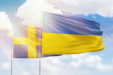 Sunny blue sky and flags of ukraine and sweden