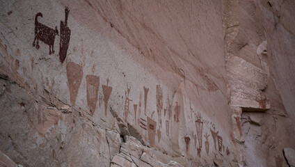 Many ancient Petroglyphs on a white band of sandstone