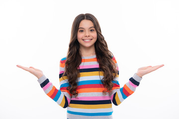 Happy girl face, positive and smiling emotions. Portrait of cute teenager child girl pointing hand showing adverts with copy space over white background.