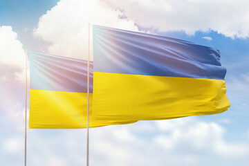 Sunny blue sky and flags of ukraine and ukraine