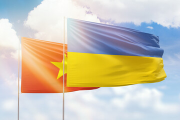 Sunny blue sky and flags of ukraine and vietnam