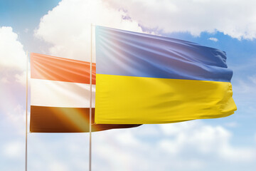 Sunny blue sky and flags of ukraine and yemen