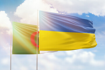 Sunny blue sky and flags of ukraine and algeria