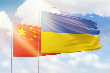 Sunny blue sky and flags of ukraine and china