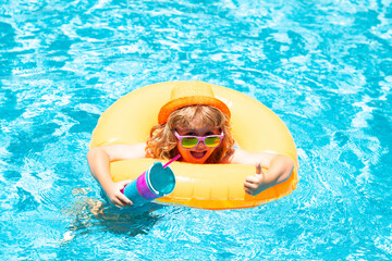 Kids swimming and playing in a pool. Child playing in swim pool. Summer fashion kids portrait. Vacation in a tropical resort. Swimwear for children. Summer rest and relaxation.