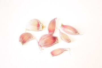 a few cloves of garlic lie on a white background