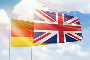 Sunny blue sky and flags of united kingdom and germany