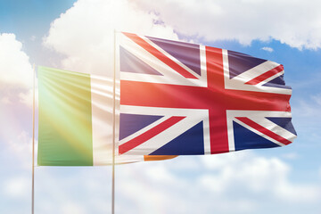 Sunny blue sky and flags of united kingdom and ireland - obrazy, fototapety, plakaty