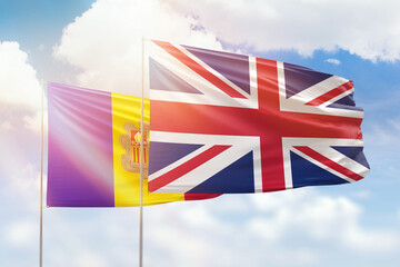 Sunny blue sky and flags of united kingdom and andorra