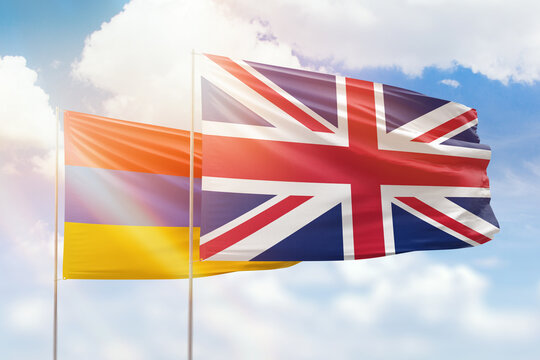 Sunny Blue Sky And Flags Of United Kingdom And Armenia